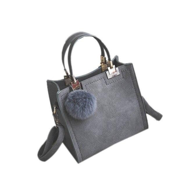 ANNA'S LAETHER HANDBAG WITH FUR BALL